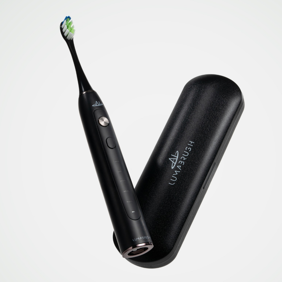 LumaBrush Black toothbrush with replacement heads on white background